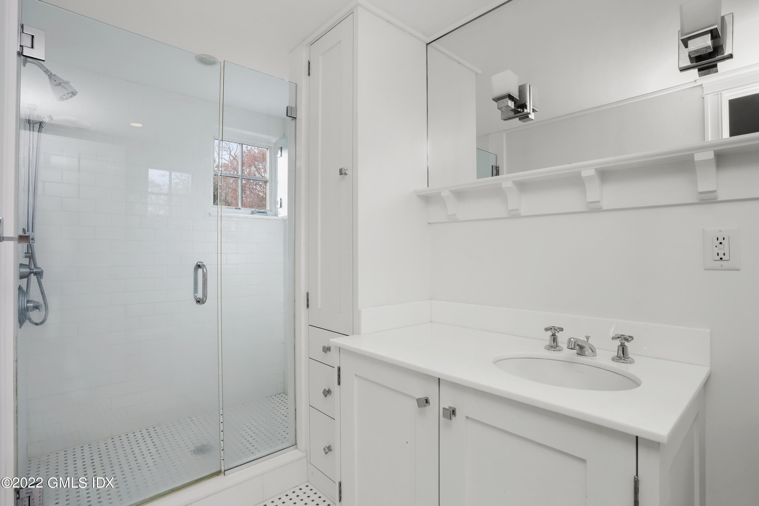 22 Glen Road Greenwich, CT 06830 - Photo 24 of 30 a bathroom with a shower sink and mirror