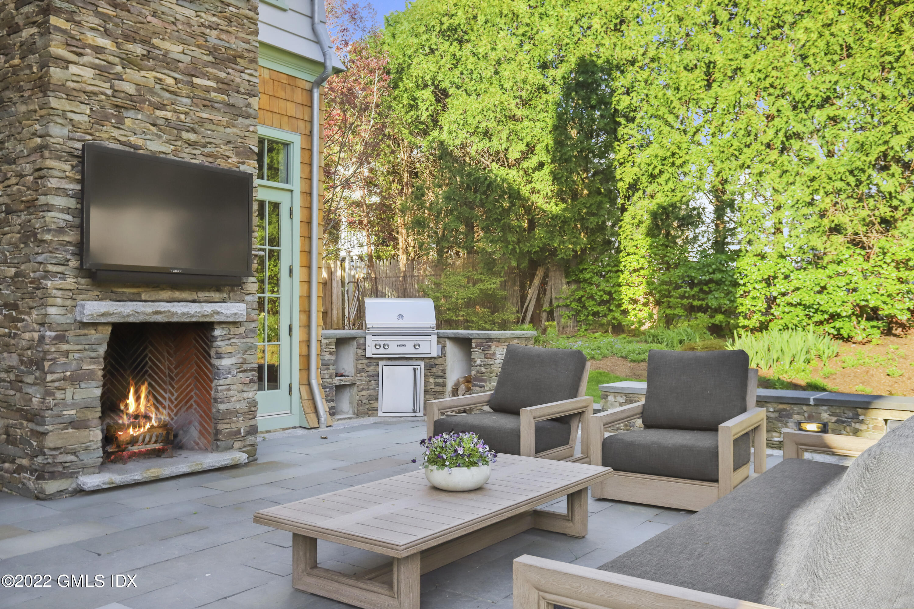 22 Glen Road Greenwich, CT 06830 - Photo 4 of 30 a outdoor living space with furniture and a fireplace