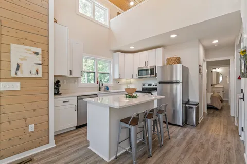 a kitchen with a table chairs stove and cabinets