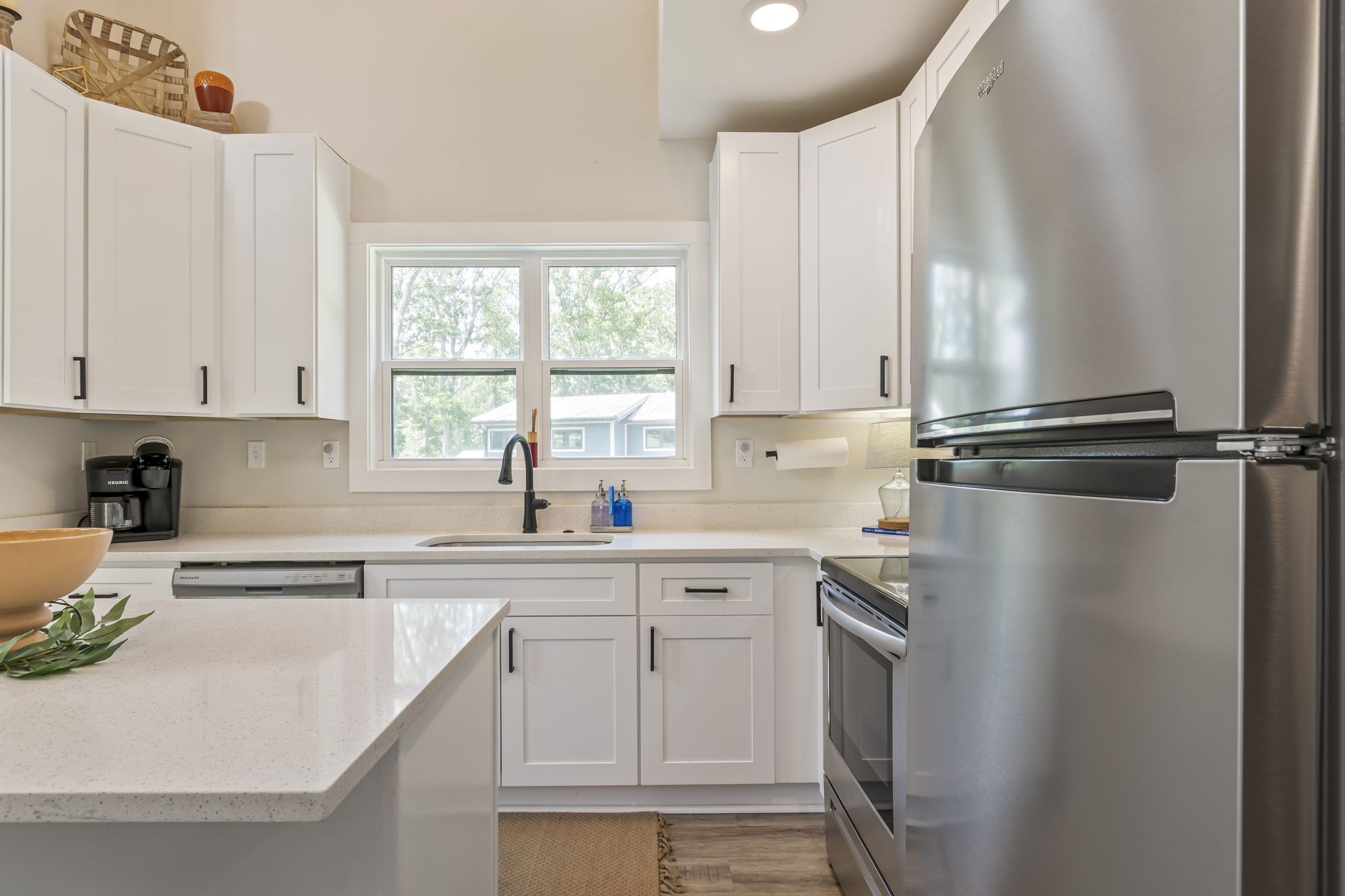 232 Waters Edge Way Tracy City, TN 37387 - Photo 14 of 62 a kitchen with a sink window and cabinets