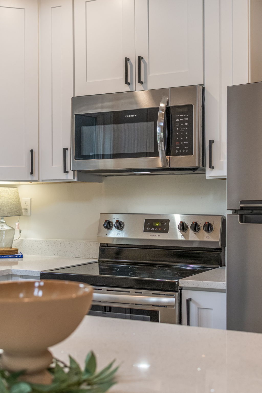 232 Waters Edge Way Tracy City, TN 37387 - Photo 21 of 63 a kitchen with stainless steel appliances a stove a microwave and cabinets