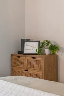 a bedroom with a bed and a mirror