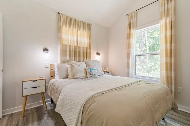 a bedroom with a bed and a mirror