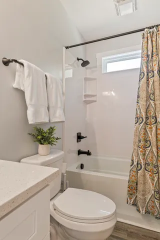 a bathroom with a toilet a sink and a mirror