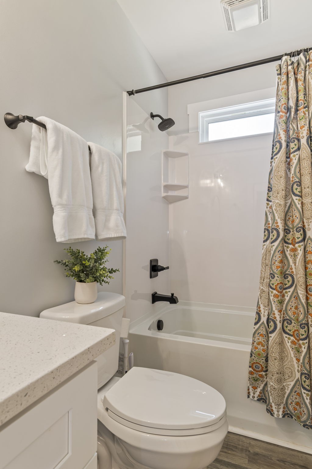 232 Waters Edge Way Tracy City, TN 37387 - Photo 28 of 62 a white toilet sitting next to a bathroom sink and a shower