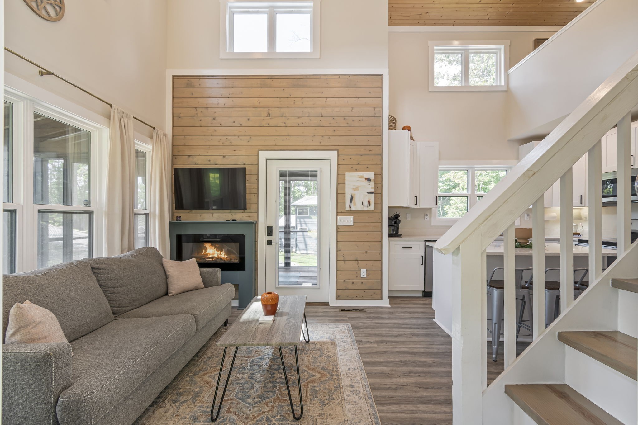 232 Waters Edge Way Tracy City, TN 37387 - Photo 6 of 62 a living room with furniture a fireplace and a floor to ceiling window