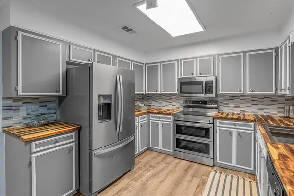 a kitchen with a refrigerator sink and microwave