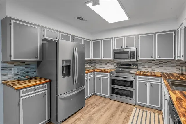 a kitchen with a refrigerator sink and microwave