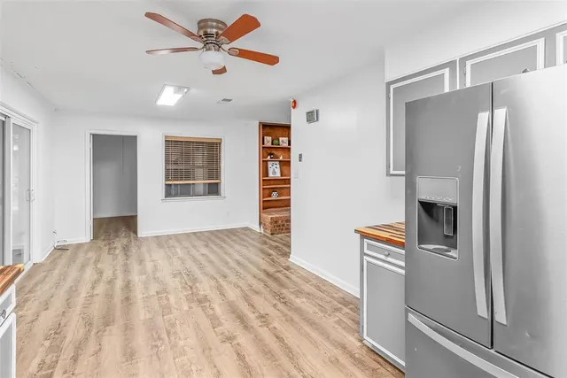 a view of a kitchen with furniture and a ceiling fan