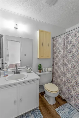 a bathroom with a toilet a sink and a mirror