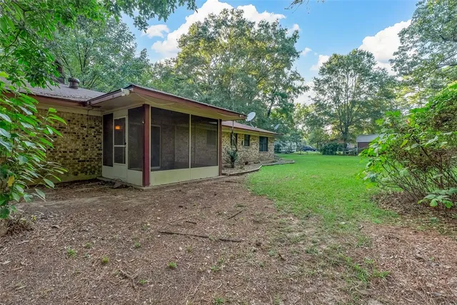 a view of a house with yard and a garden