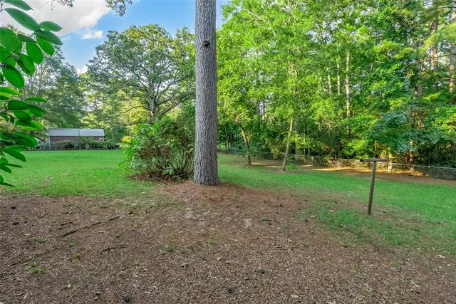 a view of a house with a backyard