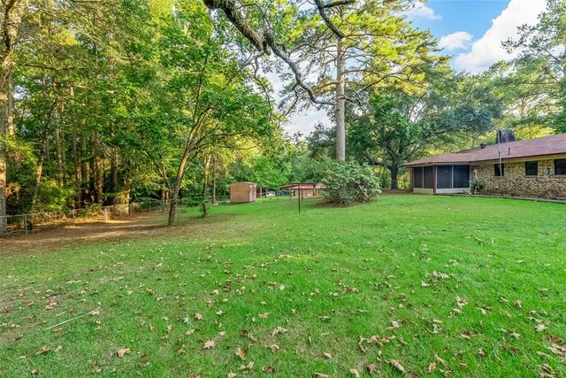 a view of house with a yard