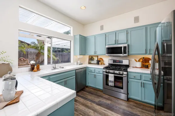 a kitchen with a sink stove and refrigerator