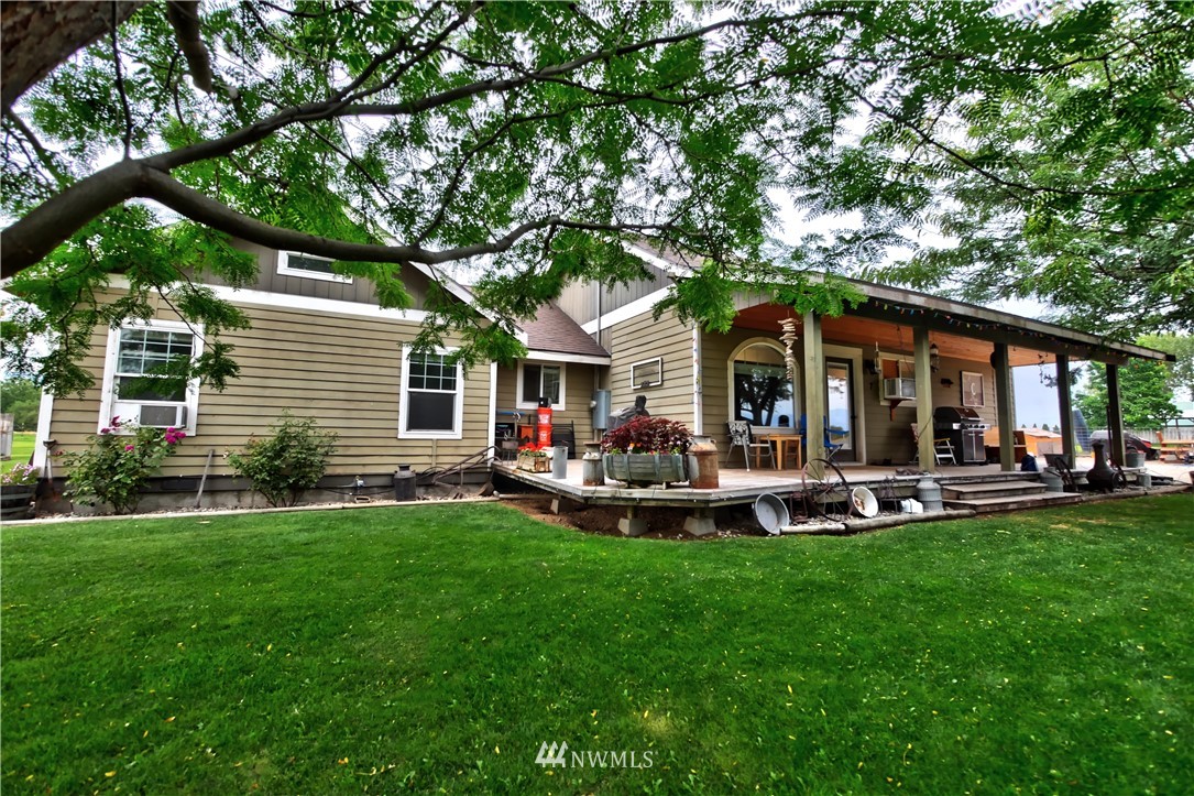 7 Woods Road Omak, WA 98841 - Photo 1 of 39 a front view of a house with swimming pool and sitting area