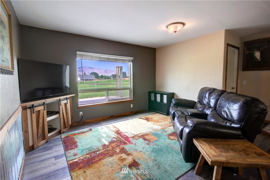 7 Woods Road Omak, WA 98841 - Photo 12 of 39 a living room with furniture and a flat screen tv