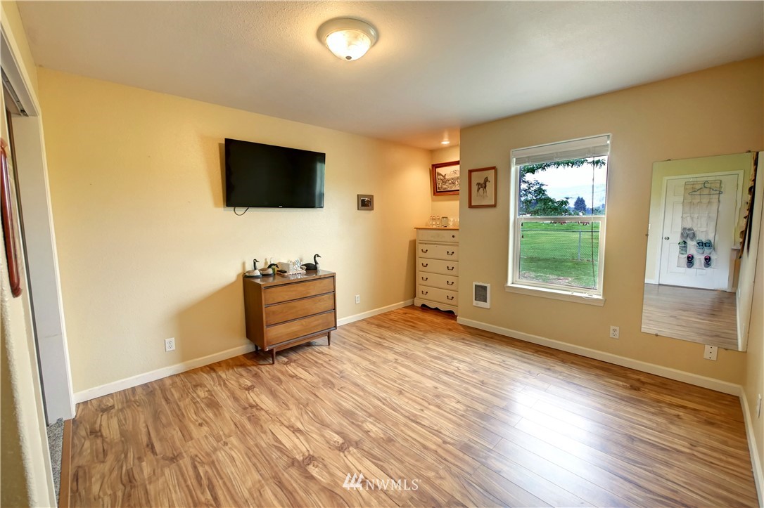 7 Woods Road Omak, WA 98841 - Photo 17 of 39 a view of a livingroom with wooden floor and a flat screen tv