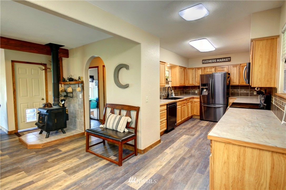 7 Woods Road Omak, WA 98841 - Photo 8 of 39 a living room with stainless steel appliances furniture a rug and a kitchen view
