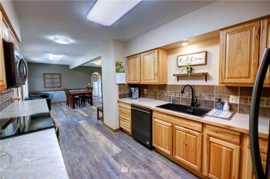 7 Woods Road Omak, WA 98841 - Photo 10 of 39 a kitchen with stainless steel appliances granite countertop sink stove top oven and cabinets