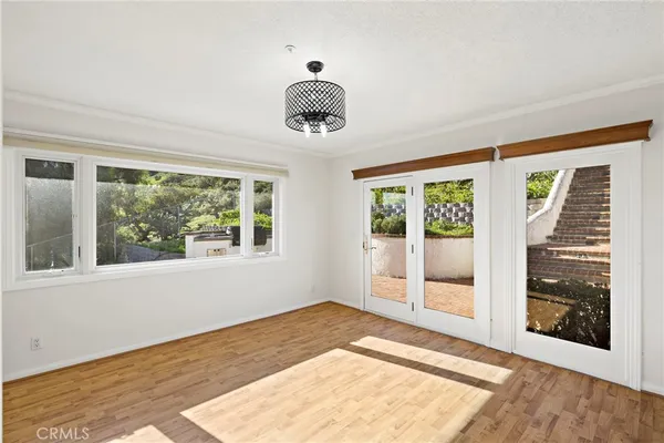 a view of an empty room with a fireplace and a window