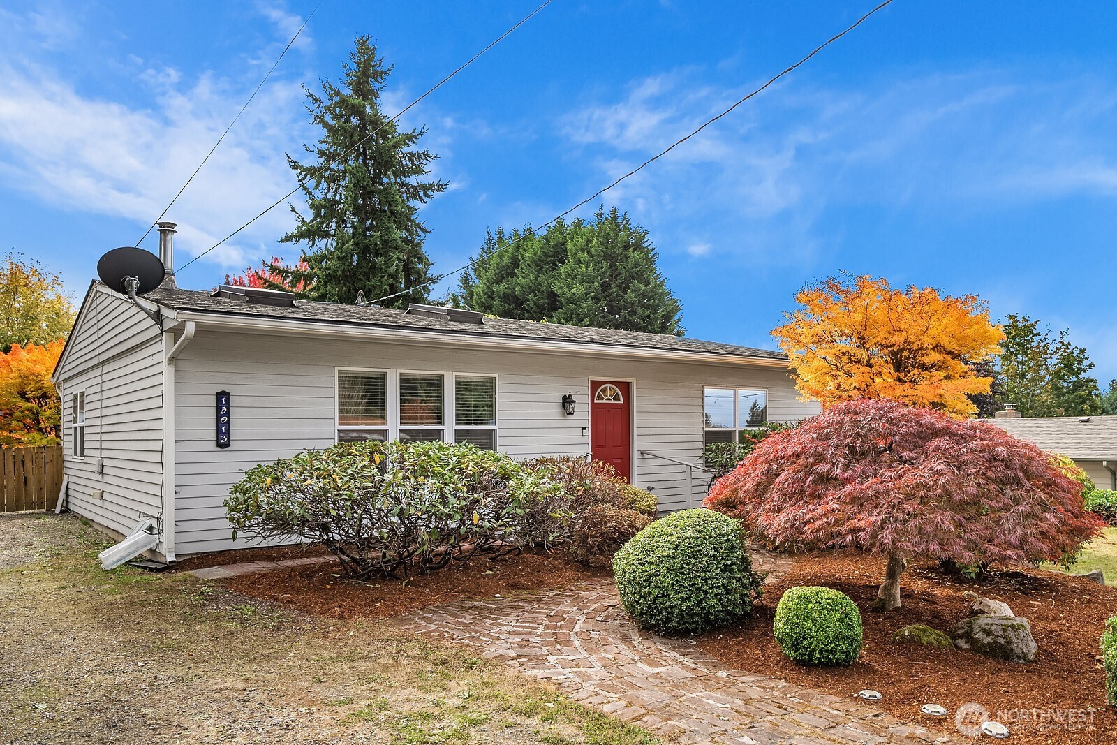 15013 Southeast 113th Street Renton, WA 98059 - Photo 1 of 26 a backyard of a house with potted plants and large tree