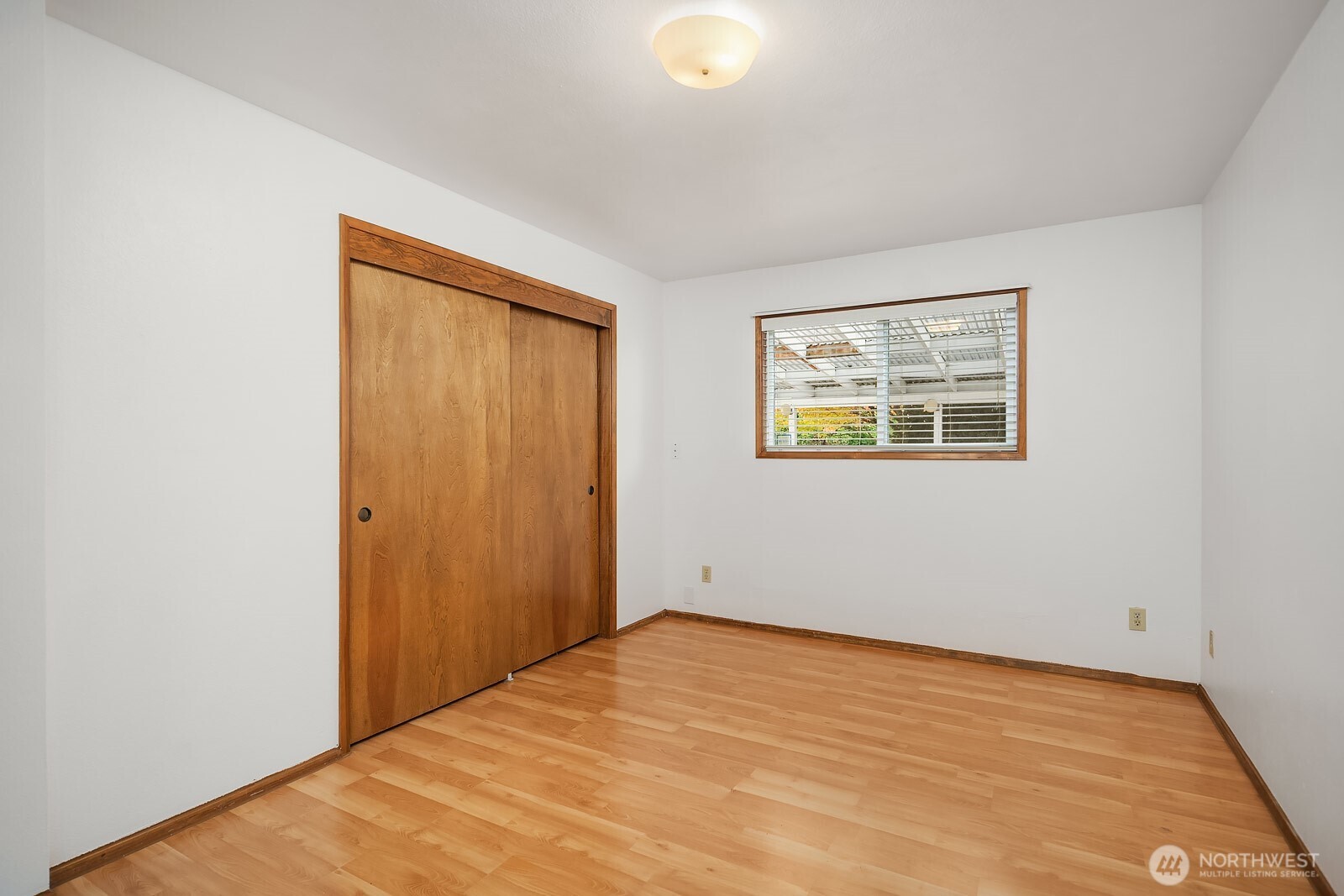 15013 Southeast 113th Street Renton, WA 98059 - Photo 13 of 26 a view of an empty room with wooden floor and a window
