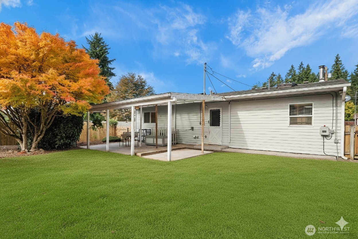 15013 Southeast 113th Street Renton, WA 98059 - Photo 18 of 26 a backyard of a house with table and chairs
