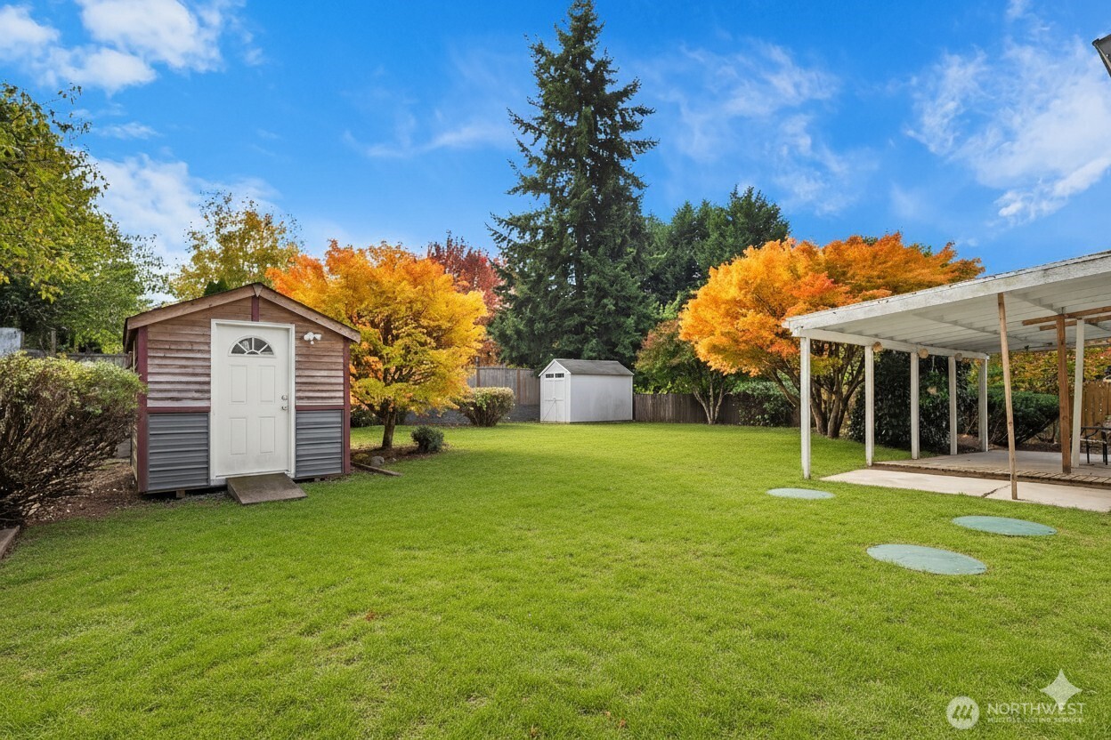 15013 Southeast 113th Street Renton, WA 98059 - Photo 22 of 26 a front view of a house with a yard and trees