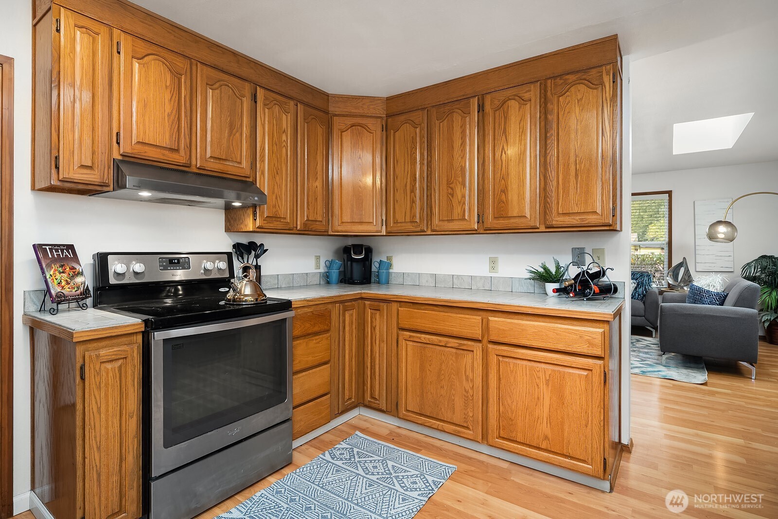 15013 Southeast 113th Street Renton, WA 98059 - Photo 8 of 26 a kitchen with stainless steel appliances granite countertop a stove a sink and a microwave