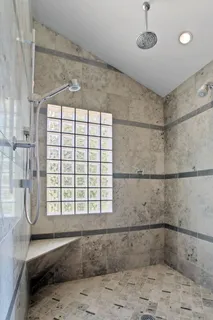 a bathroom with a shower and a bathtub