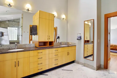 a bathroom with a granite countertop sink mirror and double