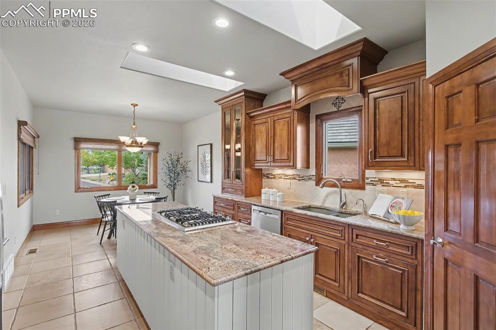 4215 Star Ranch Road Colorado Springs, CO 80906 - Photo 12 of 44 a kitchen with stainless steel appliances granite countertop a sink stove and cabinets