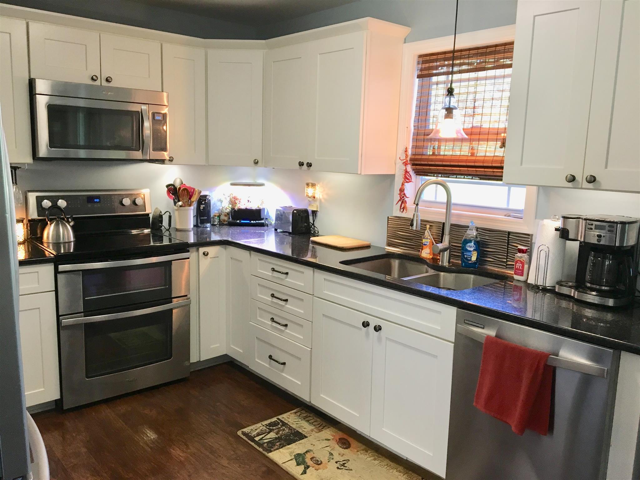 81 Rye Street McEwen, TN 37101 - Photo 3 of 16 Pretty white kitchen with granite counters and stainless appliances.