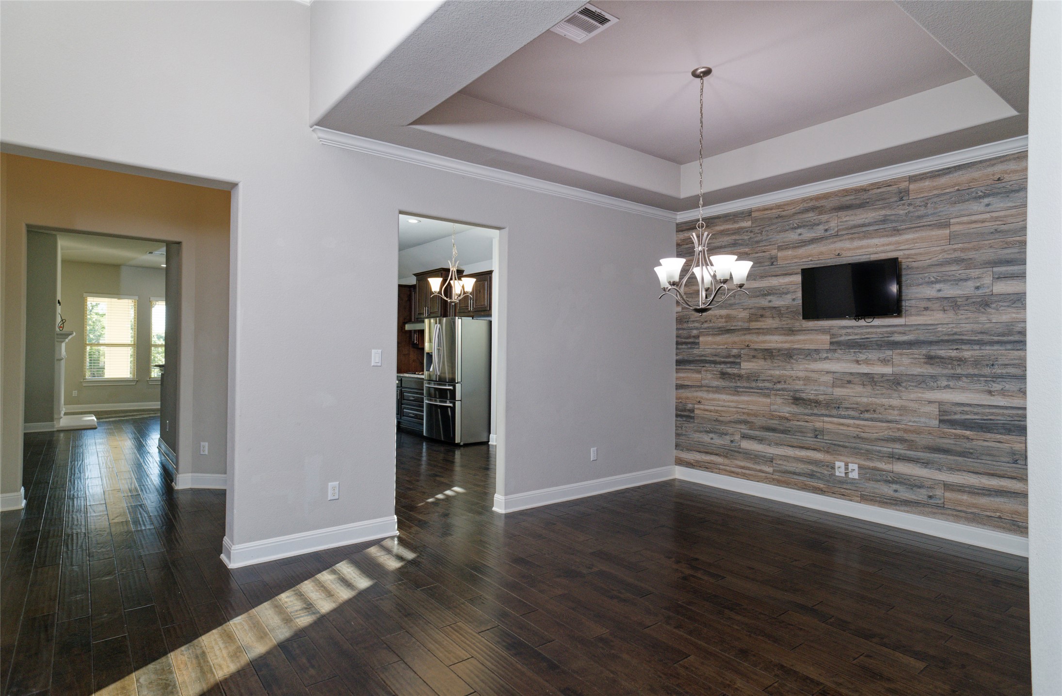 4001 Goodnight Trail Leander, TX 78641 - Photo 7 of 35 a view of an empty room with wooden floor and a window