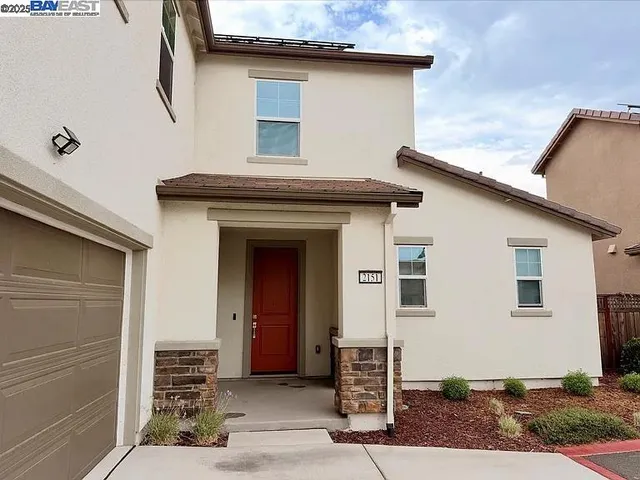 a front view of a house with garage