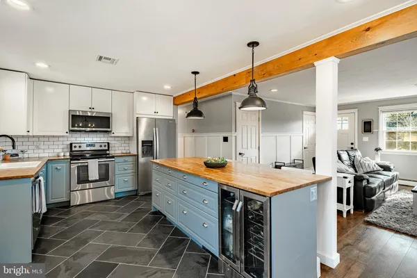 a kitchen with a sink appliances and cabinets