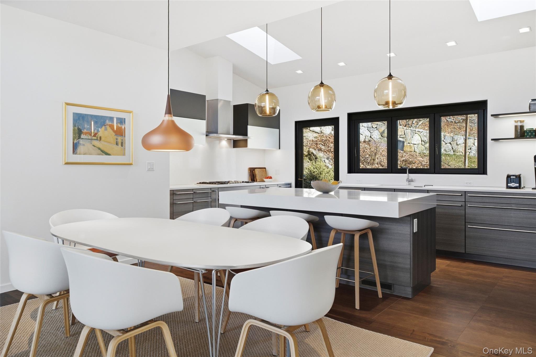 2 Lake Ridge Drive Armonk, NY 10504 - Photo 12 of 38 a kitchen with a dining table and chairs