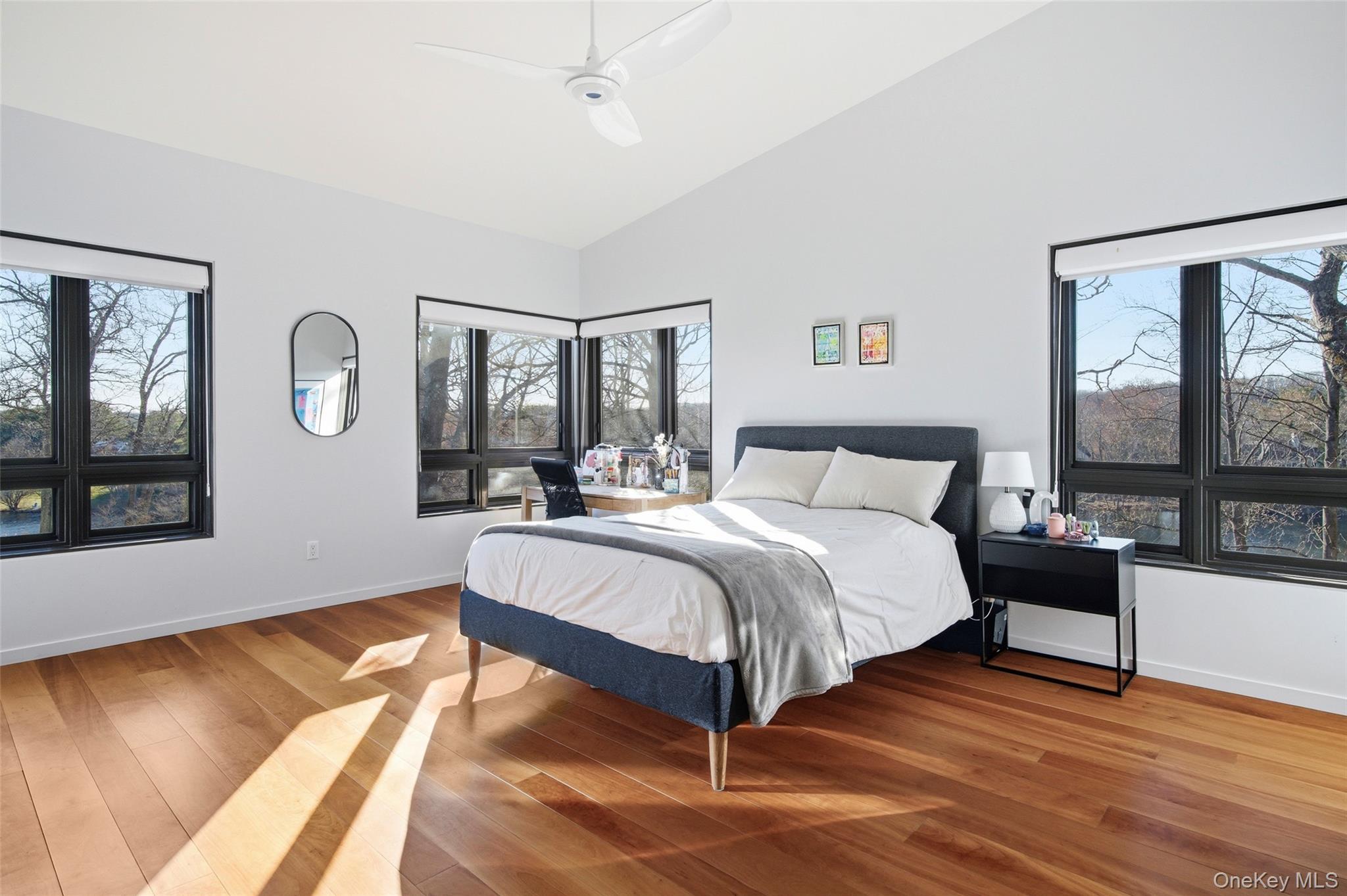 2 Lake Ridge Drive Armonk, NY 10504 - Photo 17 of 38 a spacious bedroom with a bed a mirror and a large window