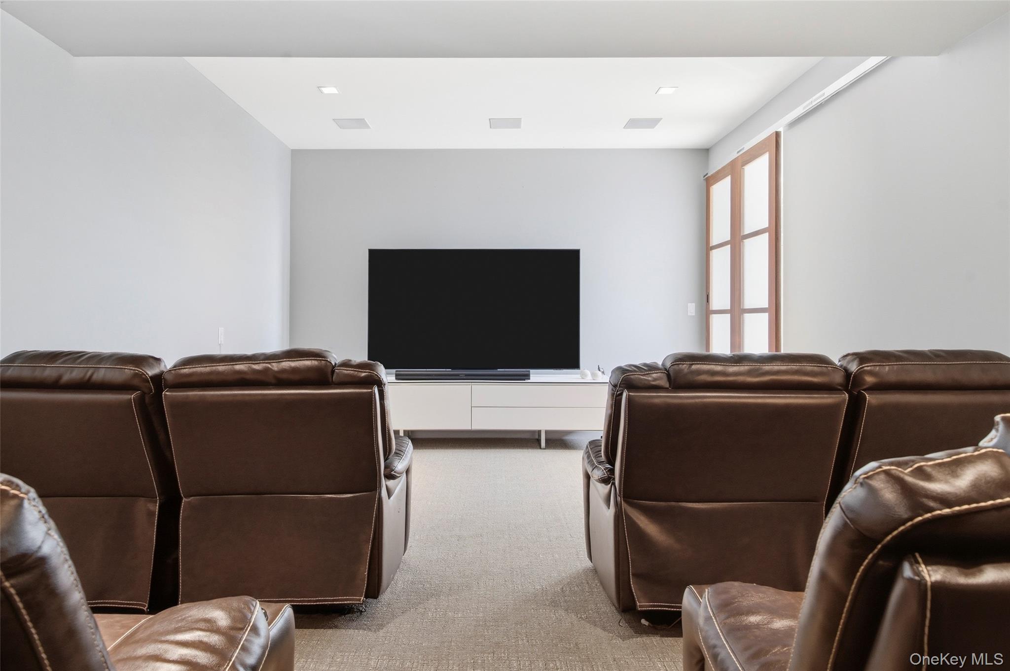 2 Lake Ridge Drive Armonk, NY 10504 - Photo 24 of 38 a living room with furniture and a flat screen tv