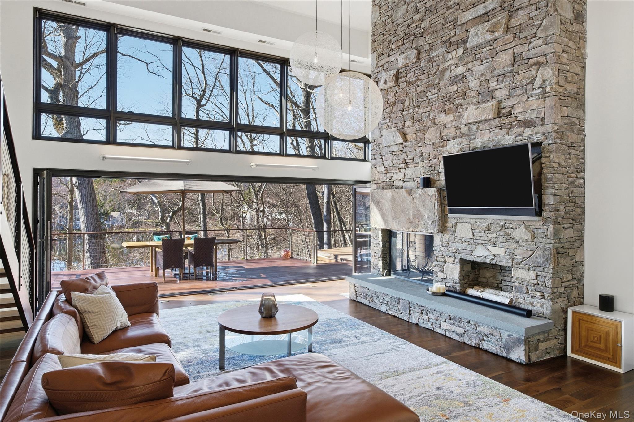 2 Lake Ridge Drive Armonk, NY 10504 - Photo 7 of 38 a living room with furniture a flat screen tv and a fireplace