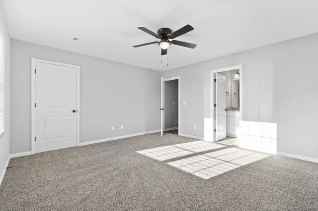 a view of a livingroom with a ceiling fan and window