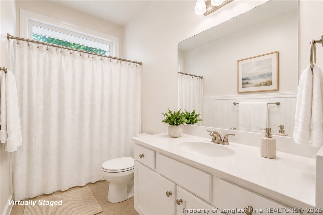 16 Ridge Road Jackson Springs, NC 27281 - Photo 14 of 50 a bathroom with a granite countertop sink a toilet and a large mirror