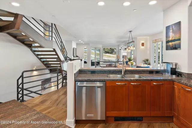 a kitchen with stainless steel appliances granite countertop a sink and a stove top oven