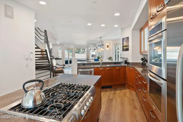 a kitchen with counter top space a stove and cabinets