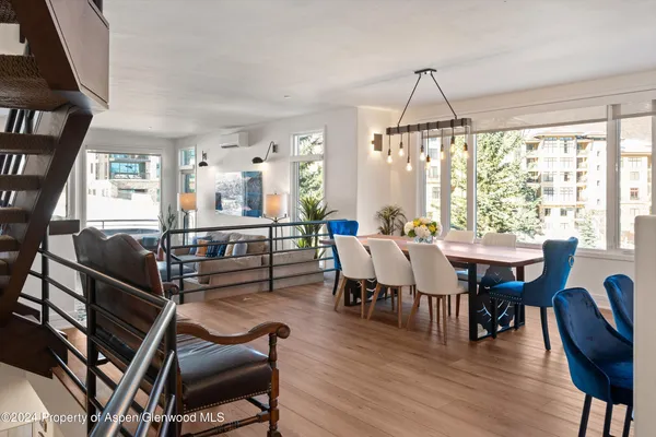 a view of a dining room with furniture window and wooden floor