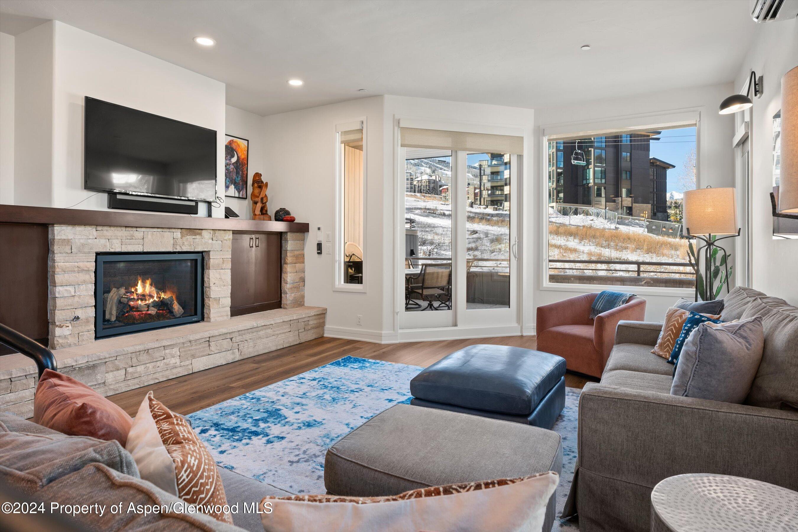 381 Ridge Road, Unit A5 Snowmass Village, CO 81615 - Photo 18 of 43 a living room with furniture and a flat screen tv