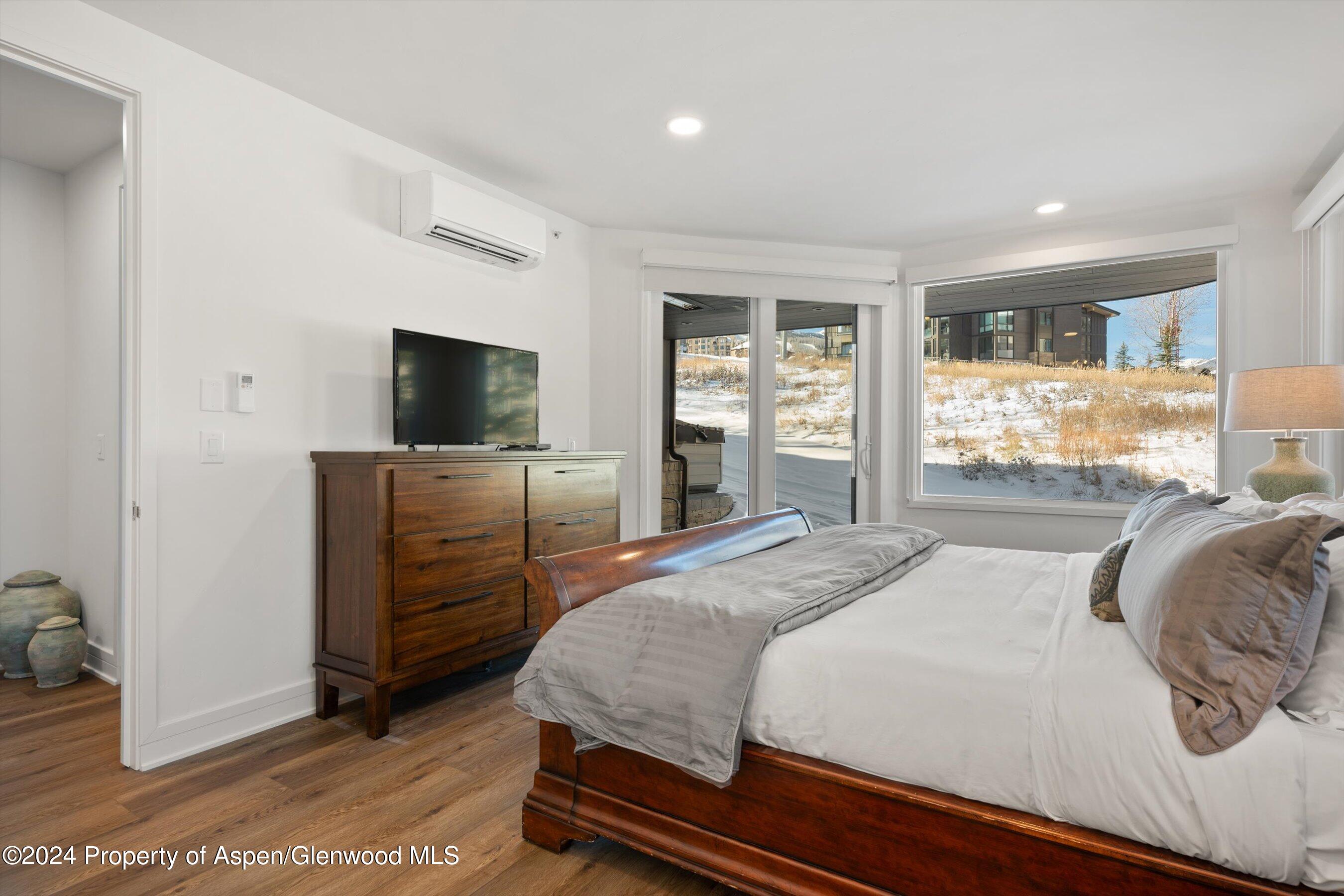 381 Ridge Road, Unit A5 Snowmass Village, CO 81615 - Photo 25 of 43 a bedroom with a bed and wooden floor