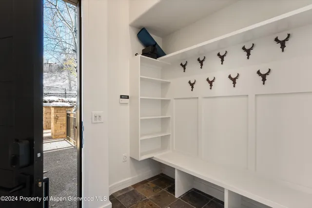 a hallway with cabinet with wooden floor
