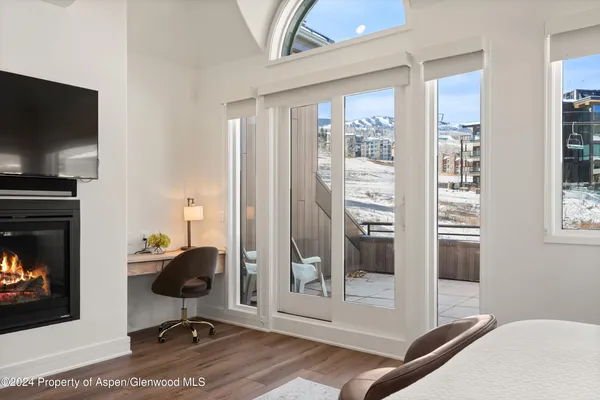 a workspace with wooden floor and a fireplace