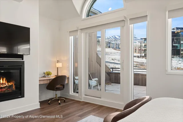 a workspace with wooden floor and a fireplace